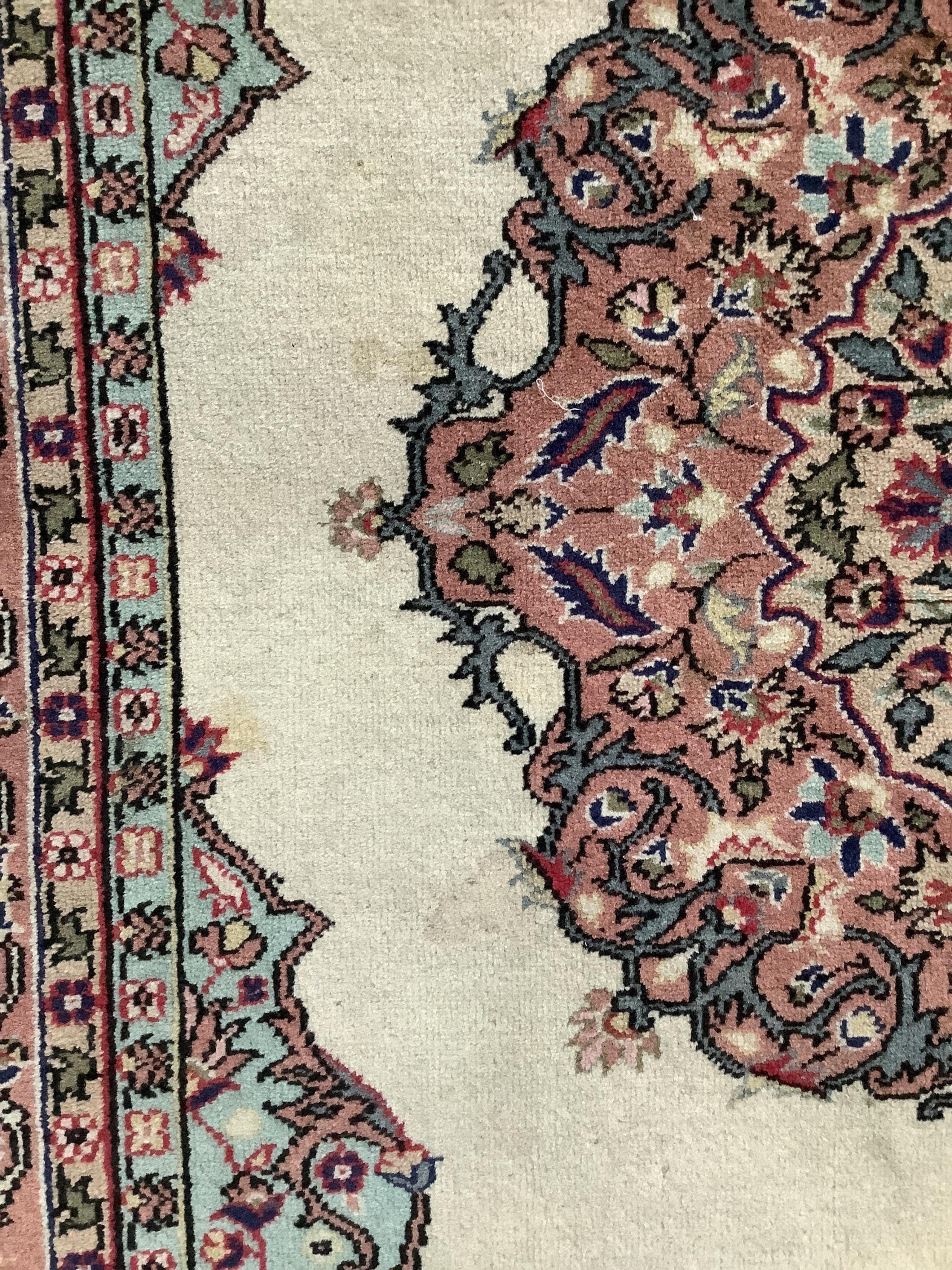 A Turkish ivory ground rug and a similar smaller red ground rug, larger 194 x 141cm. Condition - fair